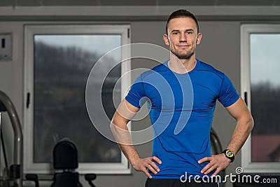 Handsome Personal Trainer Wearing Sportswear In Fitness Center Stock Photo