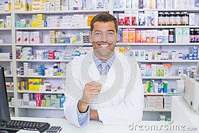 Handsome pharmacist holding paper Stock Photo