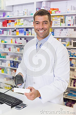 Handsome pharmacist scanning medicine box Stock Photo