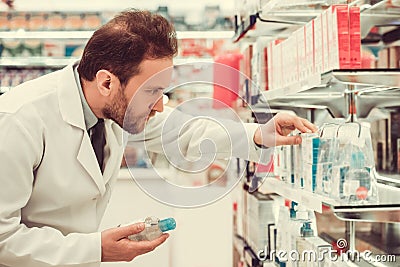 Handsome pharmacist at work Stock Photo