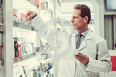 Handsome pharmacist working Stock Photo