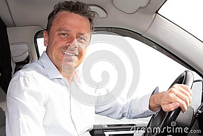 Handsome portrait of man in new modern car looking at camera Stock Photo