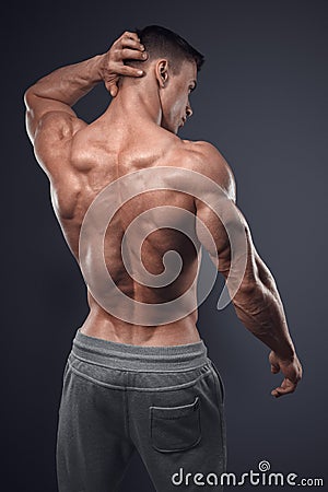 Handsome power athletic man turned back Stock Photo