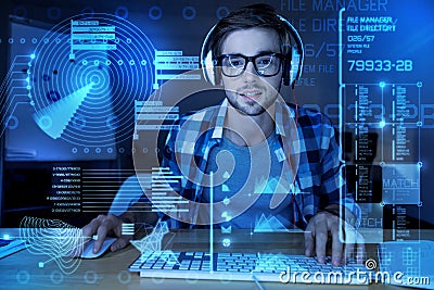Handsome programmer listening to music while working in the office Stock Photo