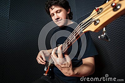 Handsome rock bass guitarist practicing. Stock Photo