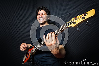 Handsome rock bass guitarist practicing. Stock Photo