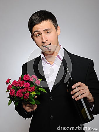 Handsome romantic man with rose flower,vine bottle Stock Photo