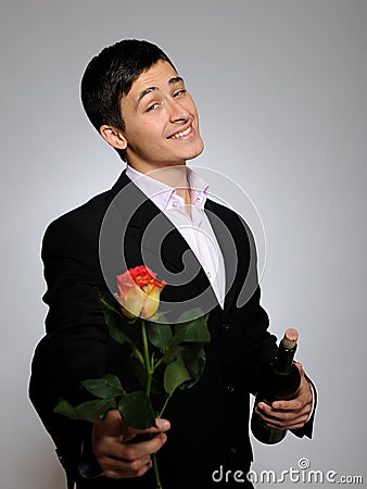 Handsome romantic young man with rose flower Stock Photo