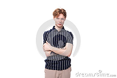 handsome 25s blond man dressed in a tank top with tattoos posing on a white background Stock Photo