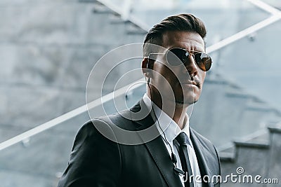handsome security guard standing in sunglasses Stock Photo