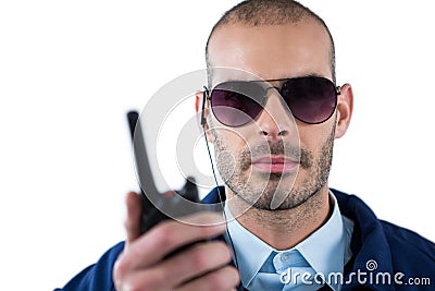 Handsome security officer talking on walkie-talkie Stock Photo