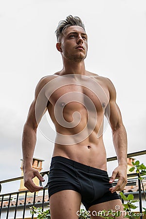 Handsome shirtless muscular young man outdoor Stock Photo