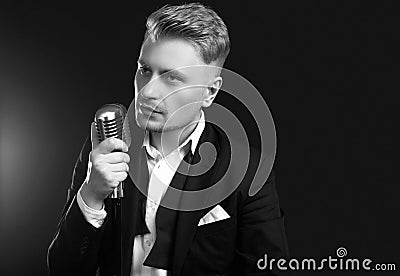 Handsome singer in elegant tuxedo and bow tie with vintage microphone Editorial Stock Photo