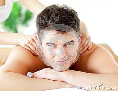 Handsome smiling man enjoying a back massage Stock Photo