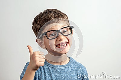 Handsome smiling toothless boy thumbs up Stock Photo