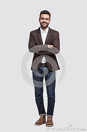 Handsome smiling young man full length studio portrait, isolated on gray background Stock Photo