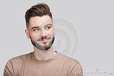 Handsome smiling young man isolated on gray background closeup portrait. Laughing joyful cheerful men studio shot Stock Photo