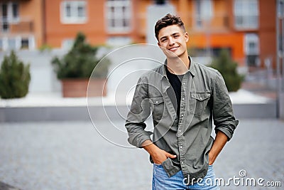 Handsome smiling young man portrait. Cheerful man looking at camera Stock Photo