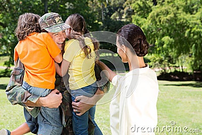 Handsome soldier reunited with family Stock Photo