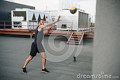 handsome sportsman catching medicine ball Stock Photo