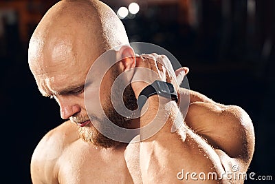 Handsome sportsman cringing from neck muscle soreness Stock Photo