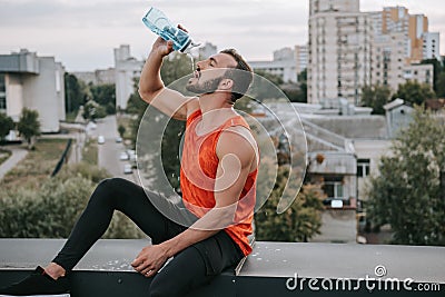 handsome sportsman drinking water Stock Photo