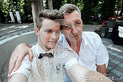 Handsome stylish groomsmen taking selfie at wedding reception, Stock Photo