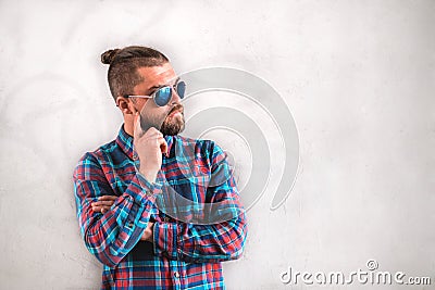 Handsome stylish man is standing near wall. Stock Photo