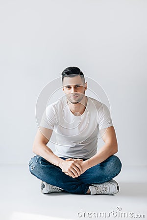 Handsome stylish man portrait sitting on floor Stock Photo