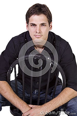 Handsome and stylish model sitting on chair Stock Photo