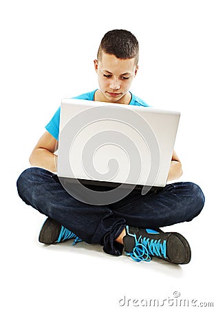 Handsome teenager boy using laptop Stock Photo