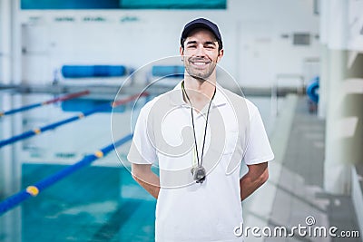 Handsome trainer standing with hands on the back Stock Photo