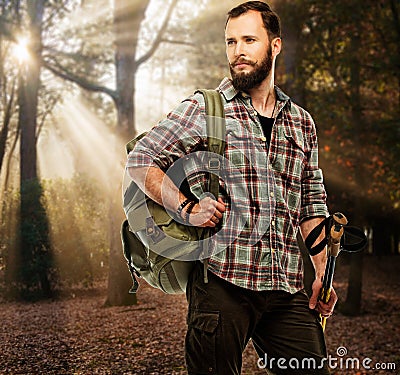 Handsome traveler in autumnal forest Stock Photo