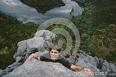 Handsome traveler climbing mountain, achievement concept Stock Photo