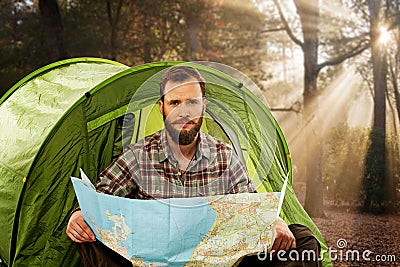 Handsome traveler near tent with a map Stock Photo