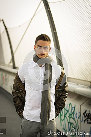 Handsome trendy man standing on a sidewalk Stock Photo