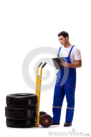 The handsome tyre repairman isolated on white Stock Photo