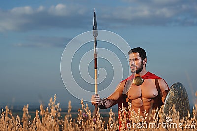 Handsome warrior going in attack with rounded shield. Stock Photo