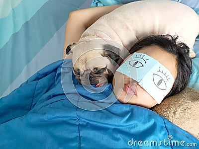 Handsome woman resting and sleeping rest with her pug dog annoy Stock Photo