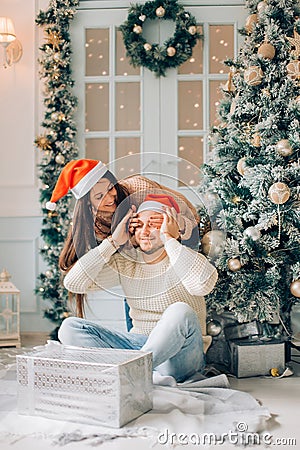 Romantic Couple Exchanging Christmas Gifts At Home Stock Photo