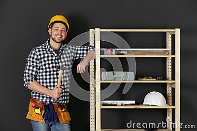 Handsome working man in hard hat with hammer. Home repair Stock Photo