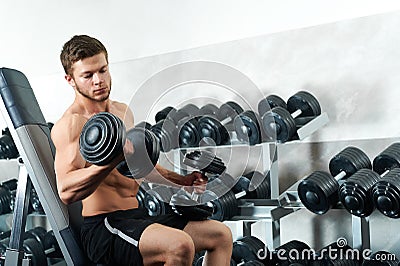 Handsome young athlete working out at the gym Stock Photo