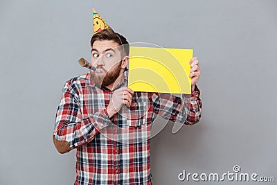 Handsome young bearded birthday man holding copyspace board Stock Photo