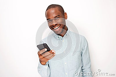 Handsome young black man holding mobile phone against white background Stock Photo