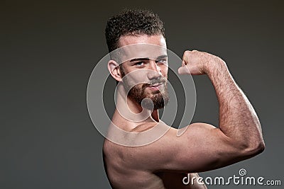 Handsome young body builder, on grey background Stock Photo