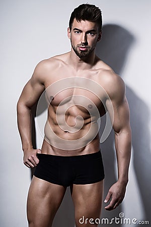 Handsome young bodybuilder showing of his fit body Stock Photo