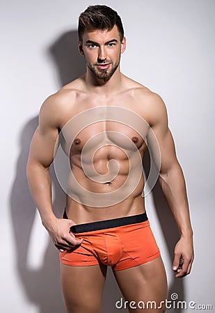 Handsome young bodybuilder showing of his fit body Stock Photo