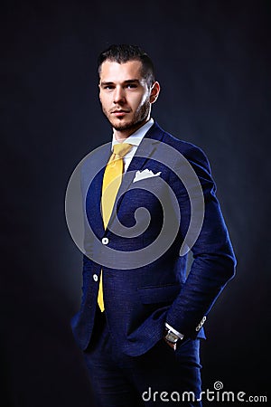 Handsome young business man standing on black Stock Photo