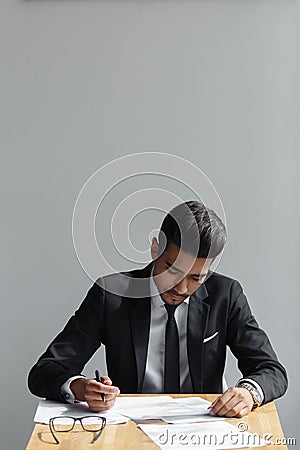 Handsome young business man writing, businessman working with documents sign up contract, sitting at the desk at office Stock Photo