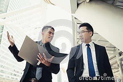 Handsome young businessman disagree, disappoint his boss. They h Stock Photo